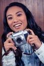 Asian woman holding digital camera Royalty Free Stock Photo