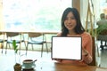 Asian woman holding digital tablet with empty screen. Royalty Free Stock Photo