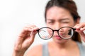 Asian woman holding glasses on white background, Selective focus on glasses , myopia and eyesight problem concept Royalty Free Stock Photo