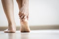 Asian woman holding heel with her hand,symptom of Plantar Fasciitis,problem of achilles tendon suffer from achilles tendinitis,