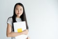 Asian woman is holding laptop on white background ,Portrait a young girl so cute when smiling and happy Royalty Free Stock Photo