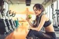 Asian woman holding and looking green apple to eat with sports e Royalty Free Stock Photo