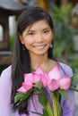 Asian woman holding lotus flowers