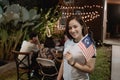 Asian woman holding malaysia flag while celebrating independence day Royalty Free Stock Photo