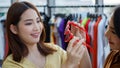 Asian woman holding mirror for friend in sunglasses Royalty Free Stock Photo