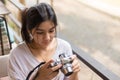 Asian woman holding mirrorless camera in the coffee cafe Royalty Free Stock Photo