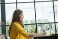 Asian woman holding pencil thinking and writing data or business planning in paper for remember and learn Royalty Free Stock Photo