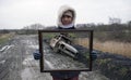 Asian Woman Holding Picture Frame With Stolen & Burnt Out Car Trick Photography. Royalty Free Stock Photo