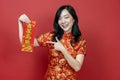 Asian woman holding red fortune blessing Chinese word which means to be blessed by a lucky star