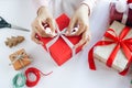 Asian woman holding red gift box on the hands offer to you on christmas tree background