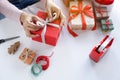 Asian woman holding red gift box on the hands offer to you on christmas tree background