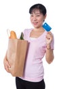 Asian woman holding a shopping bag full of groceries and credit Royalty Free Stock Photo