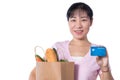 Asian woman holding a shopping bag full of groceries and credit Royalty Free Stock Photo