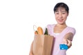 Asian woman holding a shopping bag full of groceries and credit Royalty Free Stock Photo