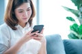 Asian woman holding smartphone with E-commerce Shopping online website Reading Online Article, Blog, vlog. Young Woman hands Royalty Free Stock Photo