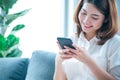 Asian woman holding smartphone with E-commerce Shopping online website Reading Online Article, Blog, vlog. Young Woman hands Royalty Free Stock Photo