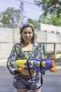 Asian woman holding a water gun play Songkran festival or Thai new year in Thailand Royalty Free Stock Photo