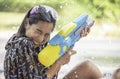 Asian woman holding a water gun play Songkran festival or Thai new year in Thailand Royalty Free Stock Photo