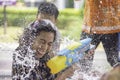 Asian woman holding a water gun play Songkran festival or Thai new year in Thailand Royalty Free Stock Photo