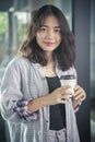 Asian woman and hot coffee cup in hand relaxing emotion smiling Royalty Free Stock Photo