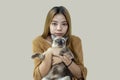 Asian woman hugging a Thai cat on yellow background. Thai teen love pet. Siamese cat sleeping with women in house Royalty Free Stock Photo