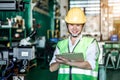 Asian woman is industrial engineer or QC team holding the clipboard Royalty Free Stock Photo