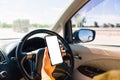 Woman inside a car and using a hand holding mobile smartphone blank screen while driving the car Royalty Free Stock Photo