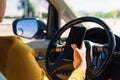 Woman inside a car and using a hand holding mobile smartphone Royalty Free Stock Photo