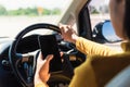 Woman inside a car and using a hand holding mobile smartphone Royalty Free Stock Photo