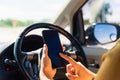 Woman inside a car and using touch screen on mobile smartphone Royalty Free Stock Photo