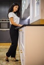 Asian woman interior designer chooses color of stone countertop for kitchen or facades