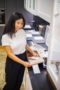 Asian woman interior designer chooses color of stone countertop for kitchen or facades