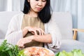 Asian woman itching rashes skin and scratching her arms caused by food allergies after eating shrimp Royalty Free Stock Photo