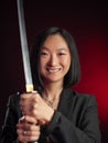 asian woman in a jacket with a katana in her hands mafia fighter emotions on her face