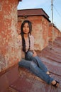 Asian woman in jeans sitting Royalty Free Stock Photo