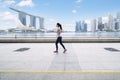 Asian woman jogging on the esplanade bridge Royalty Free Stock Photo