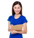 Asian woman jot note on clipoard Royalty Free Stock Photo