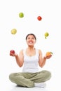 Asian woman juggling fruits