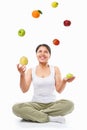 Asian woman juggling fruits Royalty Free Stock Photo