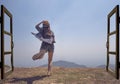 Asian woman jump out from open door to mountain top view Royalty Free Stock Photo