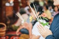 An asian woman keep a lotus, candles and incense sticks in hands for praying respect to the buddha statue Royalty Free Stock Photo