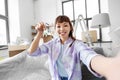 asian woman with keys taking selfie at new home Royalty Free Stock Photo