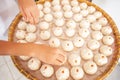 Asian woman is laying Baozi or Bun on bamboo basket