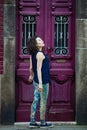 Asian woman in leggings and sneakers posing on a city street. Porto