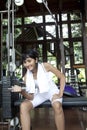 Asian woman lifhting weights in gym Royalty Free Stock Photo