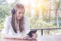 Asian woman listening music at the cafe