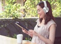 Asian woman is listening to music at home