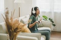 Asian women are listening to music in living room at home Royalty Free Stock Photo