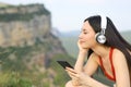 Asian woman listening to music relaxing outdoors Royalty Free Stock Photo