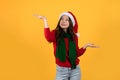 Asian woman long hair style wear red sweater, scarf and santa hat on a yellow studio background Royalty Free Stock Photo
